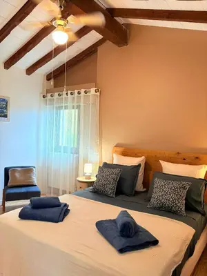 a bedroom with a large bed with blue towels on it at Las Coumeilles in Leychert