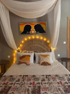 a bedroom with a bed with lights on it at O'MAZETTE CHAMBRE ROMANTIQUE VUE JARDIN AVEC PISCINE découverte de l'Aude in Fabrezan