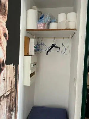 a room with a closet with a shelf and toiletries at Appart Gwen in Gruissan