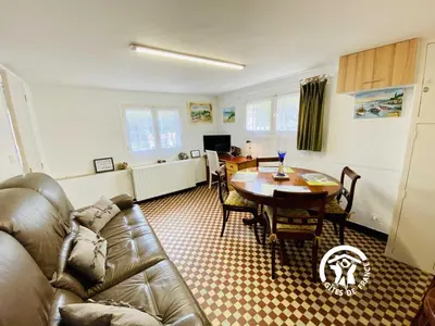 a living room with a couch and a table at Au bien-etre in Villemoustaussou