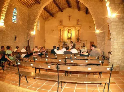 a group of people sitting in a church at Maison tout confort belle terrasse sud in Sigean