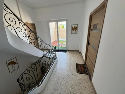 a hallway with a spiral staircase in a house at White and Cotton Suite in Saint-Paul-de-Fenouillet