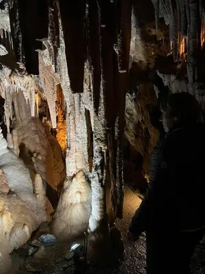 a woman standing in a cave with ice formations at White and Cotton Suite in Saint-Paul-de-Fenouillet