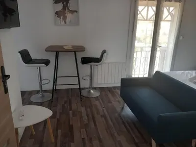 a living room with a couch and a table and chairs at White and Cotton Suite in Saint-Paul-de-Fenouillet