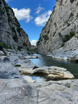 a river in a canyon with rocks in the water at Suite Noire et Blanche in Saint-Paul-de-Fenouillet