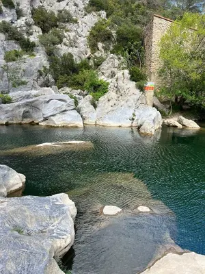 a body of water with rocks and a mountain at Suite Noire et Blanche in Saint-Paul-de-Fenouillet