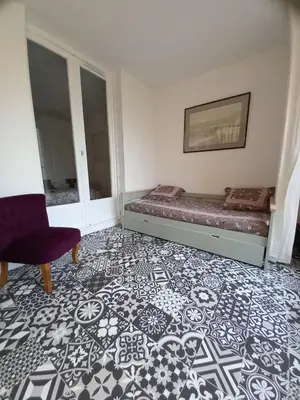 a bedroom with a bed and a chair at T2 standing Gruissan in Gruissan