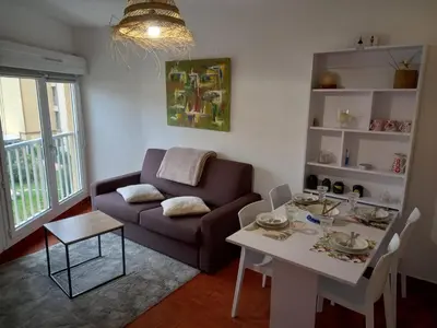 a living room with a couch and a table at T2 standing Gruissan in Gruissan
