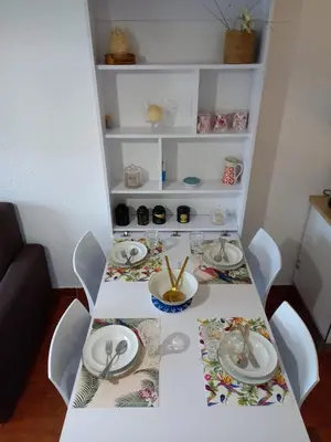 a white table with plates and utensils on it at T2 standing Gruissan in Gruissan