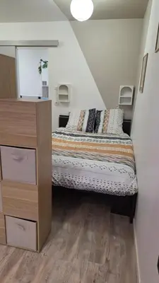 a small bedroom with a bed and a dresser at Le petit cocon centre ville in Tuchan