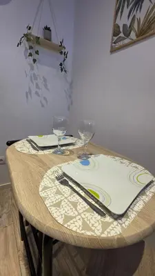 a table with two wine glasses and a table cloth at Le petit cocon centre ville in Tuchan