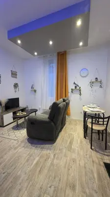 a living room with a couch and a table at Le petit cocon centre ville in Tuchan