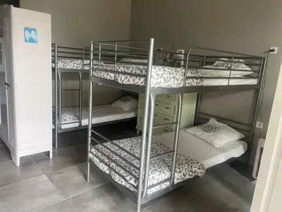 a room with three bunk beds in a room at Dortoir de 12Lits in Mas-Saintes-Puelles