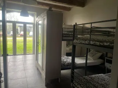 a room with two bunk beds and a doorway at Dortoir de 12Lits in Mas-Saintes-Puelles