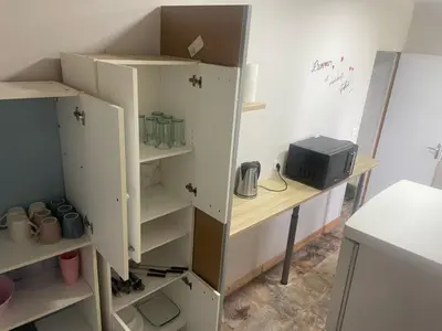 a room with white shelves and a computer on a desk at Dortoir de 12Lits in Mas-Saintes-Puelles