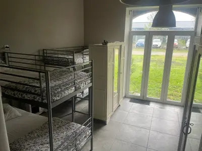 a room with three bunk beds and a window at Dortoir de 12Lits in Mas-Saintes-Puelles