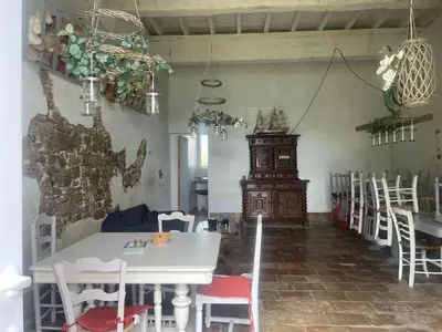 a dining room with a white table and chairs at Dortoir de 12Lits in Mas-Saintes-Puelles