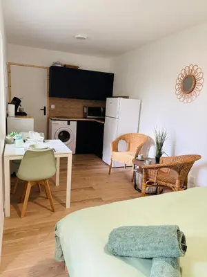 a living room with a kitchen and a dining room at Studio Proche Gare & Centre Ville in Castres
