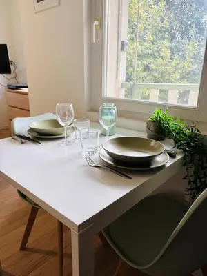 a living room with two chairs and a table at Studio Proche Gare & Centre Ville in Castres