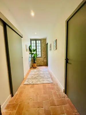 a hallway with two doors and a tile floor at Le Moulin de La Grave 450m2 in Lagrasse