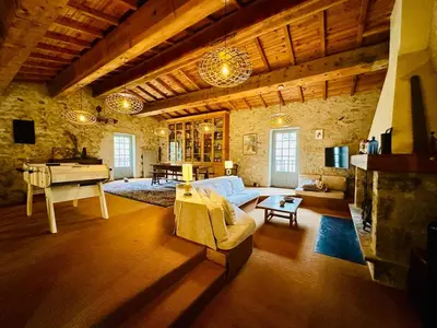 a living room with a couch and a piano at Le Moulin de La Grave 450m2 in Lagrasse