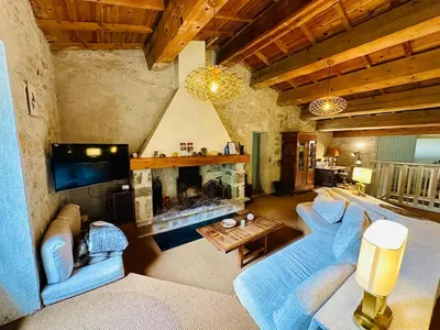 a living room with a couch and a fireplace at Le Moulin de La Grave 450m2 in Lagrasse