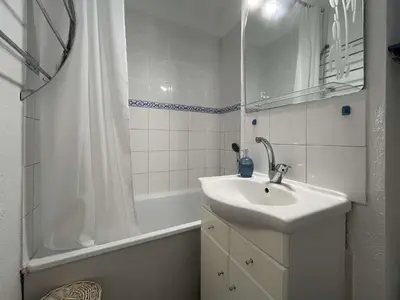 a white bathroom with a sink and a shower at Appartement climatisé, vue sur le port technique - GN160-331 in Gruissan