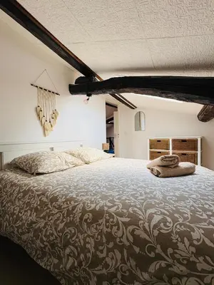 a bedroom with a large bed with two towels on it at Appartement Proche Place Soult l 2 CH in Castres
