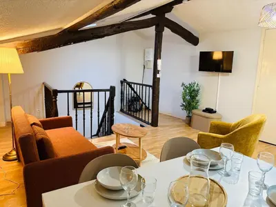 a living room with a table and chairs at Appartement Proche Place Soult l 2 CH in Castres