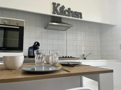 a kitchen with a table with glasses on it at Aux 138 bis in Carcassonne