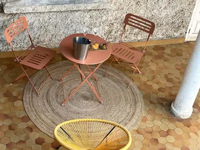 a table and two chairs and a table and a chair at Aux 138 bis in Carcassonne