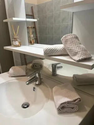 a bathroom with a sink and a mirror at Aux 138 bis in Carcassonne