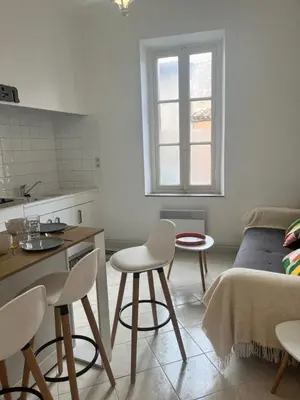 a kitchen with a table and chairs in a room at Aux 138 bis in Carcassonne