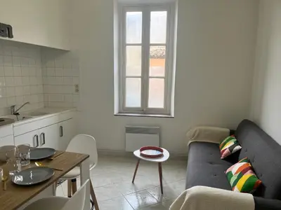 a living room with a couch and a table at Aux 138 bis in Carcassonne