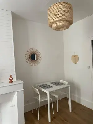 a dining room with a white table and chairs at Le Mi-Stud in Castres
