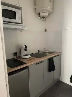 a small kitchen with a sink and a microwave at Le Mi-Stud in Castres