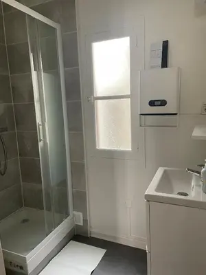 a small bathroom with a shower and a sink at Le Mi-Stud in Castres