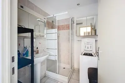 a small bathroom with a sink and a shower at La Dali - Maison de vacance proche de la mer in Sigean