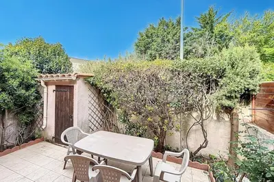 a table and chairs sitting on a patio at La Dali - Maison de vacance proche de la mer in Sigean