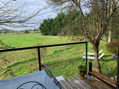 a view of a field from the porch of a house at Roulotte et Nature in Mirepoix