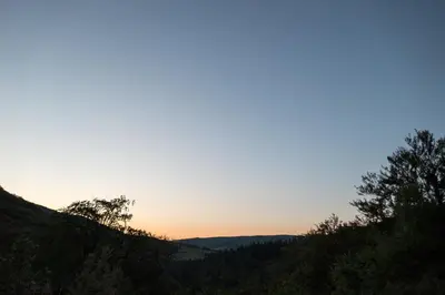 a view of the sunset from the top of a hill at Maison Au Milieu De La Foret in Labastide-Rouairoux
