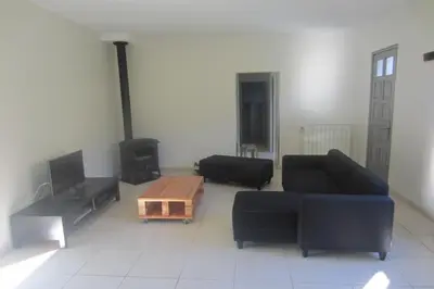 a living room with two couches and a coffee table at Maison Au Milieu De La Foret in Labastide-Rouairoux