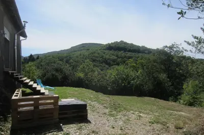 a house with a view of a mountain at Maison Au Milieu De La Foret in Labastide-Rouairoux