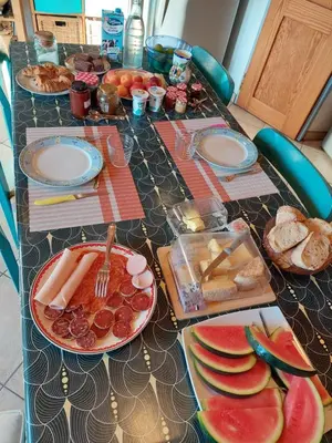 a long table with plates of food on it at Chambre d'hôte Les Maisons de Gaïa in Tuchan