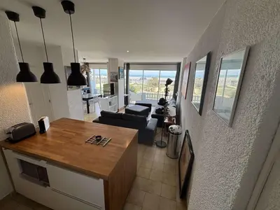 a kitchen and living room with a view of a living room at Appartement 2 pièces Port la Nouvelle PN430-026 in Port-la-Nouvelle