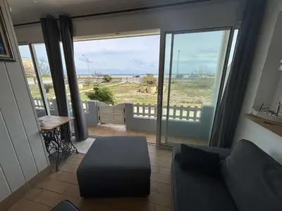a living room with a couch and a large window at Appartement 2 pièces Port la Nouvelle PN430-026 in Port-la-Nouvelle