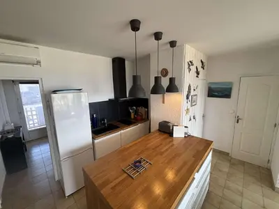 a kitchen with a refrigerator and a wooden counter top at Appartement 2 pièces Port la Nouvelle PN430-026 in Port-la-Nouvelle