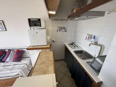 a small kitchen with a couch and a table in a room at Appartement 2 pièces PORT LA NOUVELLE PN430-030 in Port-la-Nouvelle