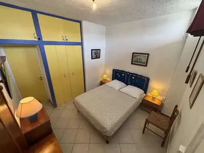 a small bedroom with a bed and two yellow cabinets at Appartement 2 pièces PORT LA NOUVELLE PN430-030 in Port-la-Nouvelle
