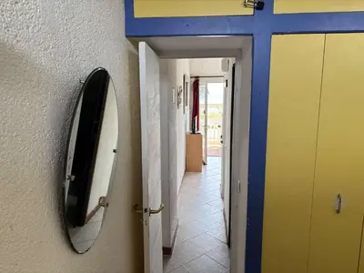 a bedroom with a bed and two lamps and a door at Appartement 2 pièces PORT LA NOUVELLE PN430-030 in Port-la-Nouvelle